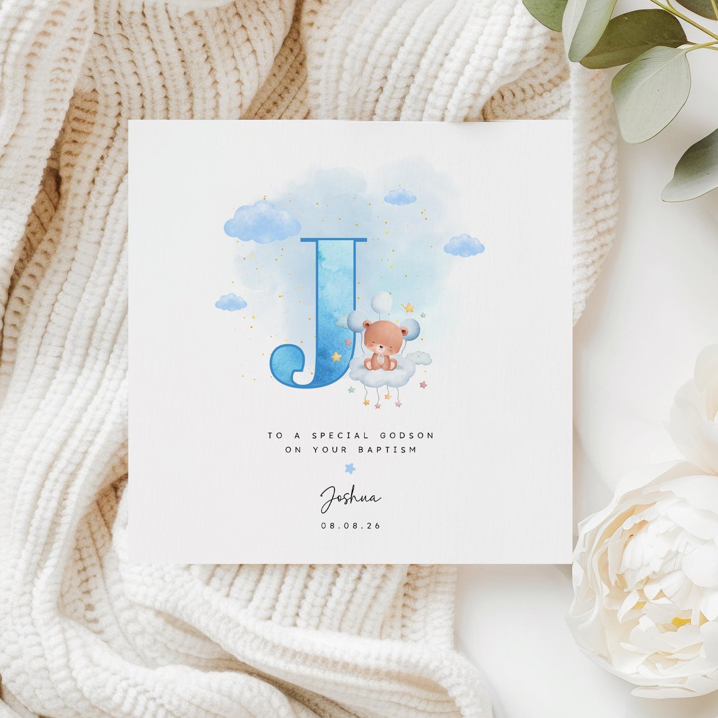 Personalised baptism card for baby boy with blue watercolour letter, teddy bear on cloud, and custom name and date. Ideal for christenings or naming days.
