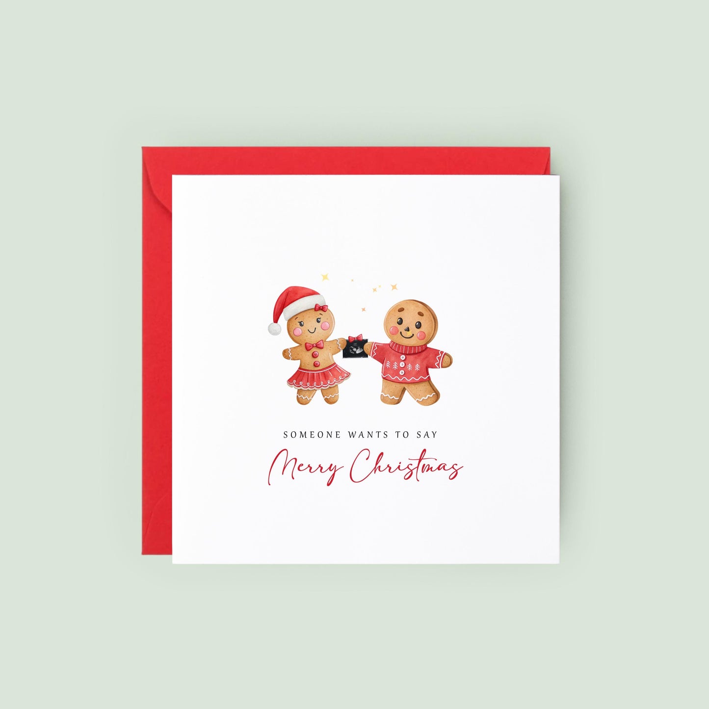 Christmas pregnancy announcement card featuring a festive gingerbread couple holding a baby scan with the message "Someone Wants to Say Merry Christmas."