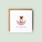 Boxer Mother’s Day card with watercolour Boxer in soft pink rose floral frame with greenery and text “Happy Mother’s Day to my favourite human”, shown as a square white 148x148mm (6x6) card with Kraft envelope behind.