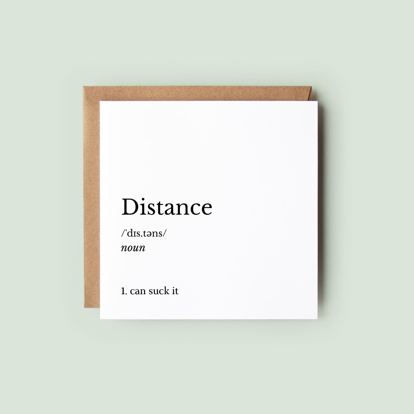 Funny long distance “Distance definition” greeting card reading “Distance… can suck it”, shown on a square white card with Kraft envelope behind, blank inside, 6x6 inches.