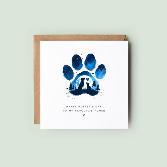 Dog Mum Mother’s Day card with blue night-sky paw print design showing a dog and human silhouette scene, text “Happy Mother’s Day to my favourite human”, shown as a square white 148x148mm (6x6) card with Kraft envelope behind.