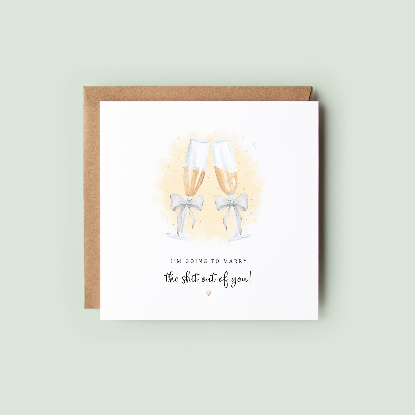 Funny wedding day card with watercolour champagne flutes and text “I’m going to marry the sh*t out of you!”, shown as a square white 148x148mm (6x6) card with Kraft envelope behind.