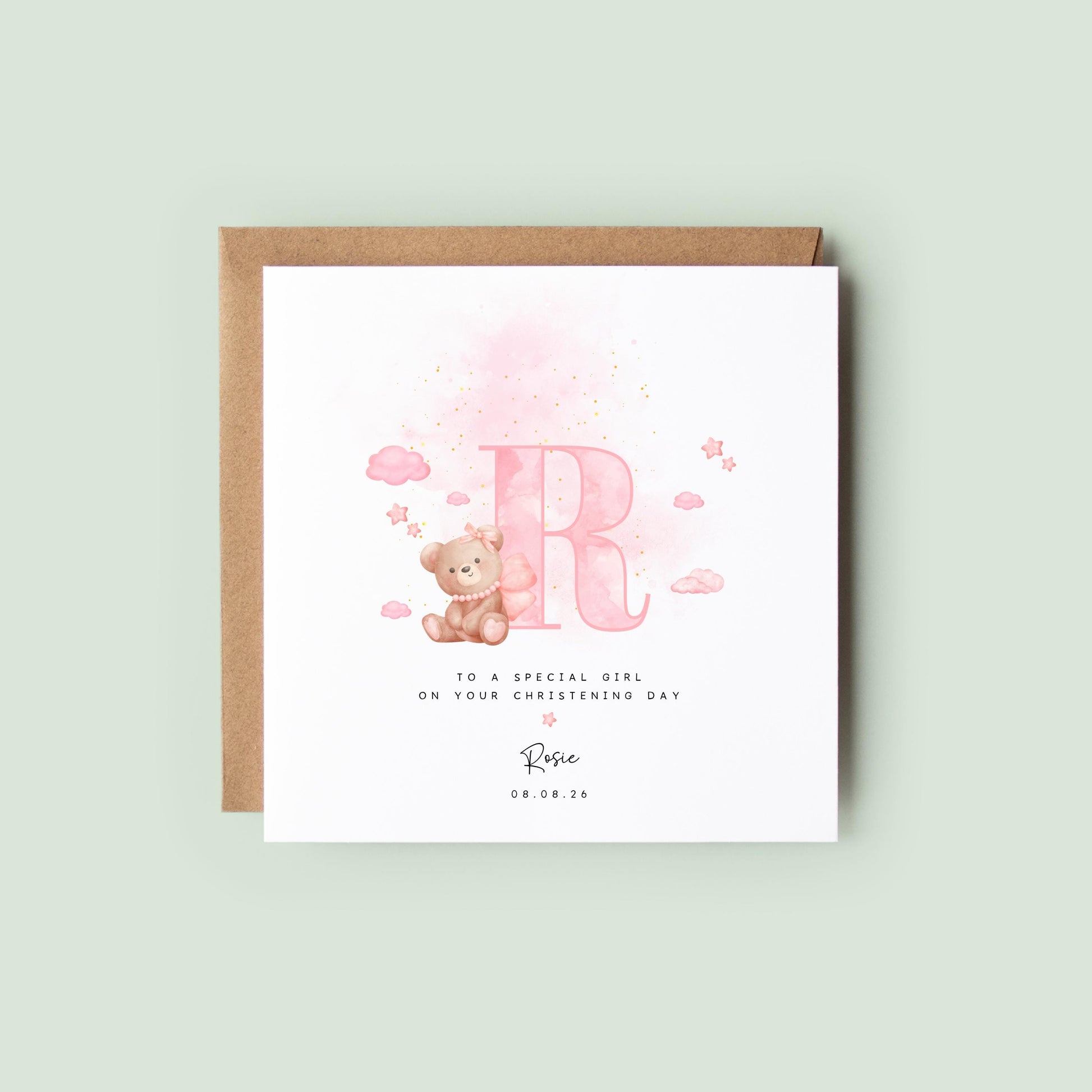 Personalised baptism card for baby girl with pink watercolour letter, teddy bear on cloud, and custom name and date. Perfect for christening or naming day keepsakes.