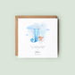 Personalised baptism card for baby boy with blue watercolour letter, teddy bear on cloud, and custom name and date. Ideal for christenings or naming days.