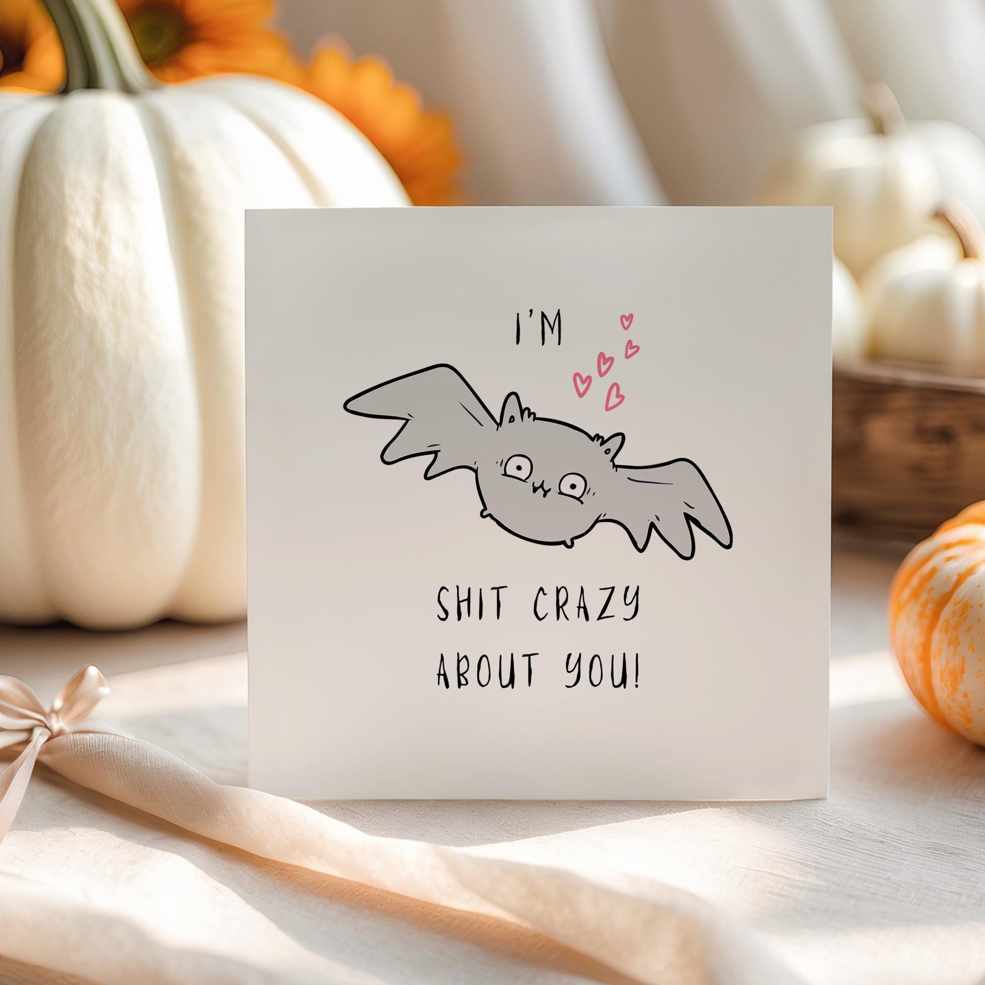 Funny illustrated Halloween card featuring a wide-eyed cartoon bat with hearts, and the caption “I’m Bat Shit Crazy About You”, perfect for spooky season love