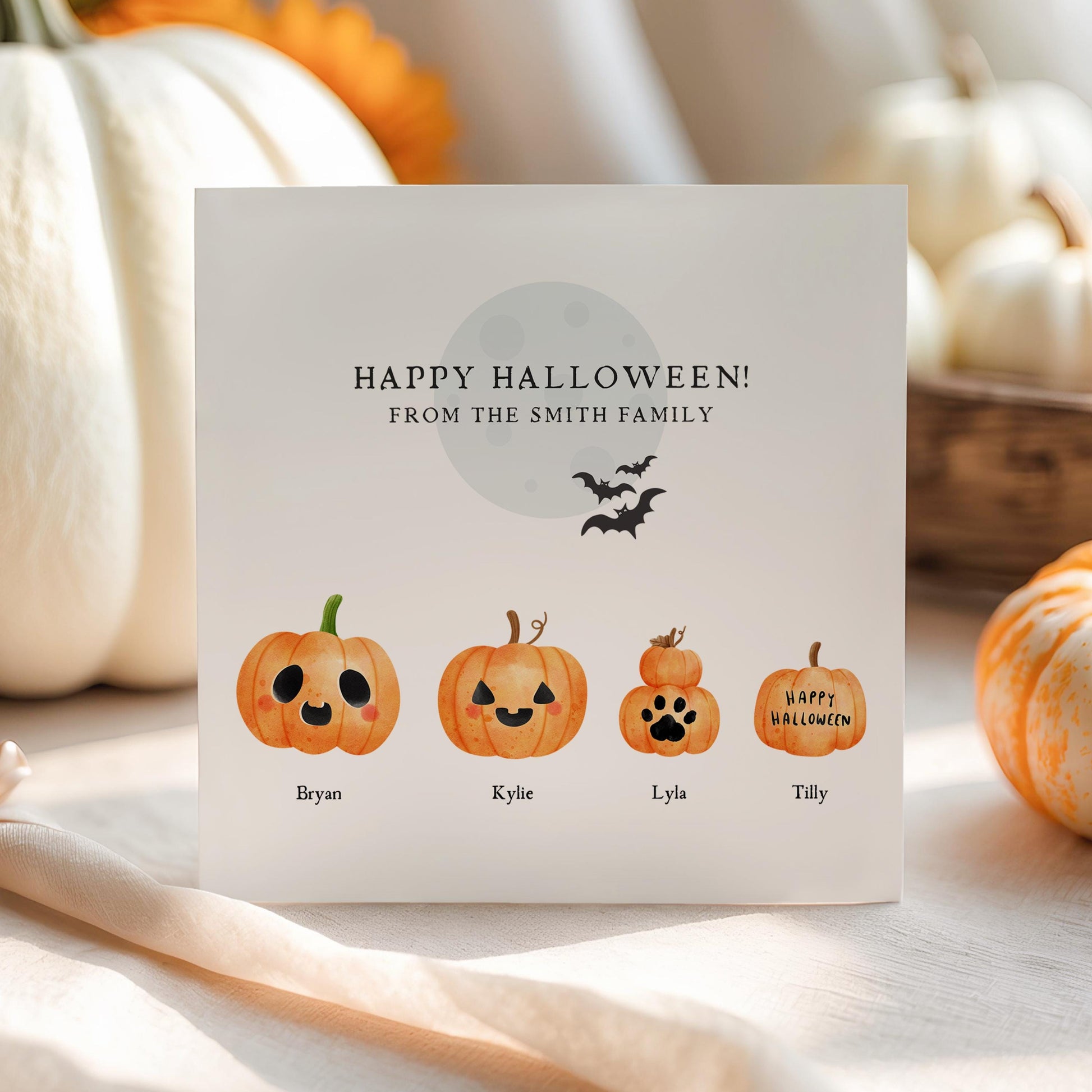 Personalised Halloween family greeting card featuring customisable watercolour pumpkin characters with names underneath and "Happy Halloween from the Smith Family" at the top.