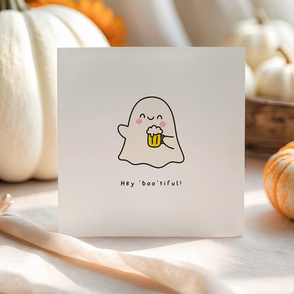 Cute Halloween greeting card featuring a smiling ghost holding a frothy beer with the pun "Hey Boo'tiful!"