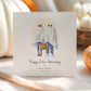 Personalised linen anniversary card featuring a ghost couple in Halloween costumes holding a pumpkin bucket, with custom names and wedding date.
