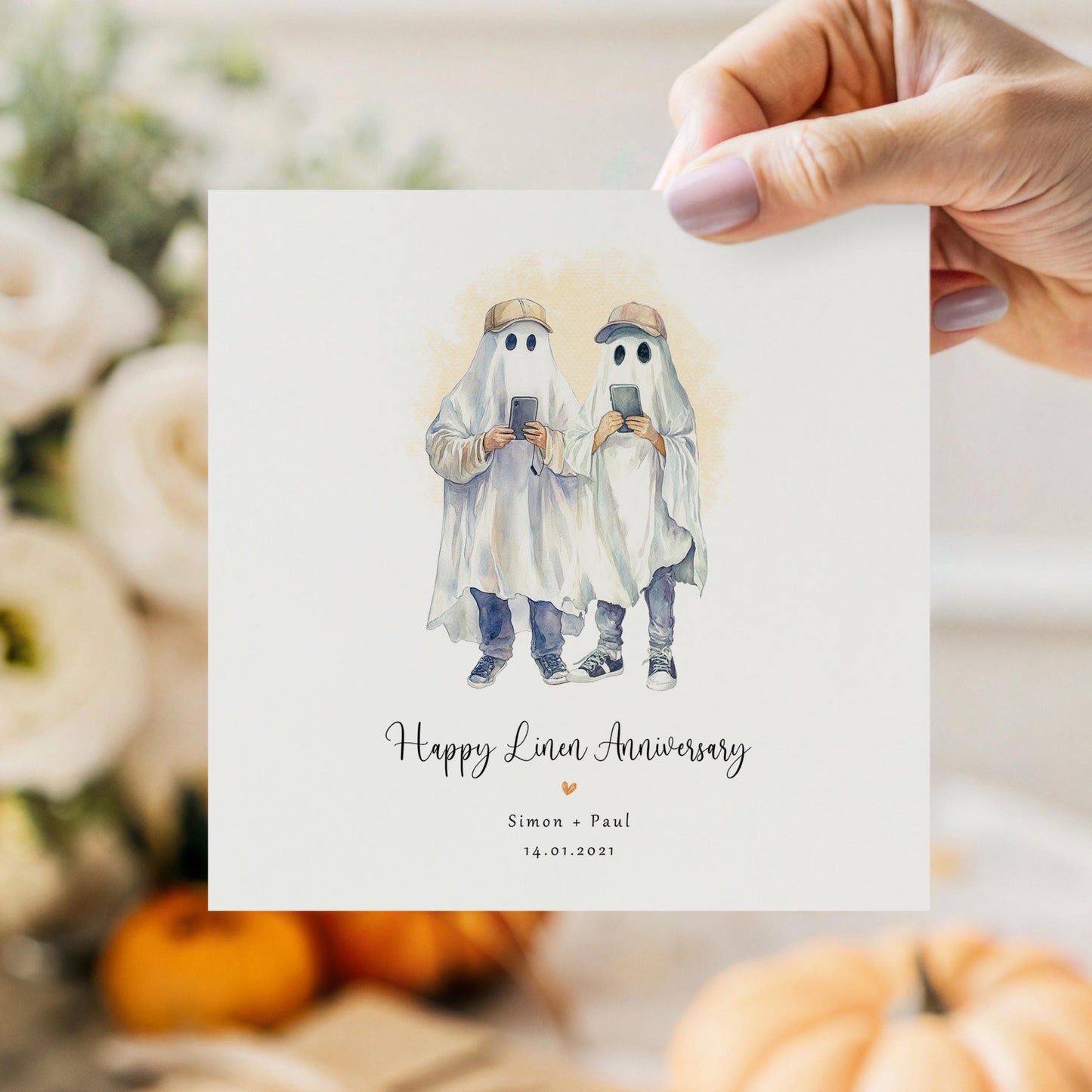Personalised linen anniversary card featuring two male ghosts holding phones in a humorous Halloween-style design, with names and anniversary date.