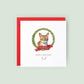 Personalised Abyssinian cat Christmas card featuring a watercolour cat illustration inside a festive wreath with a red ribbon, text reads “Merry Christmas Fred”.