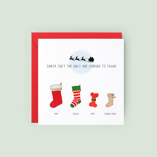 Personalised Christmas pregnancy announcement card with festive stockings and “Santa isn’t the only one coming to town” text, ideal for sharing baby news.