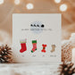 Personalised Christmas pregnancy announcement card with festive stockings and “Santa isn’t the only one coming to town” text, ideal for sharing baby news.
