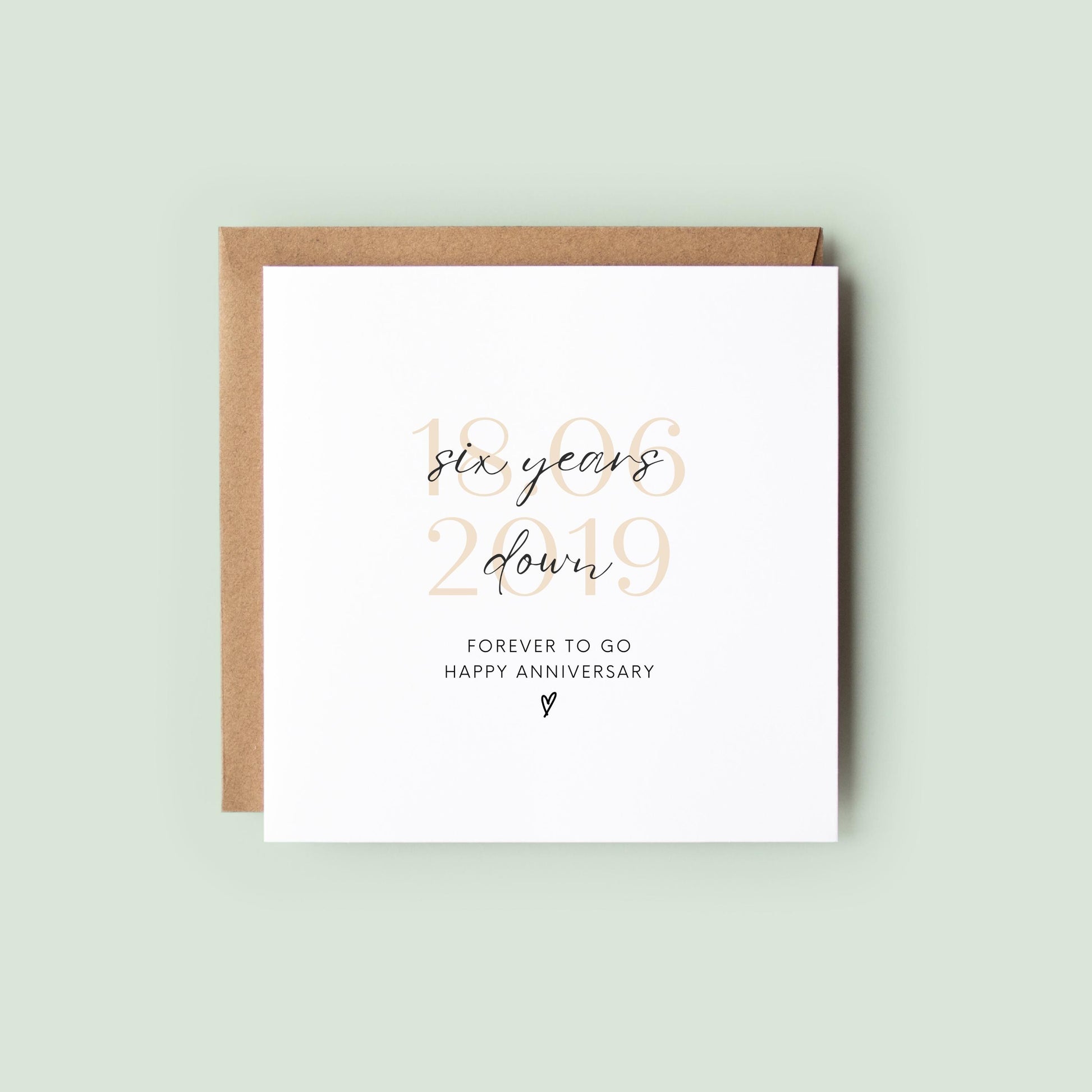 Personalised six-year anniversary card featuring soft beige date, script text reading “Six Years Down”, and a small heart detail.