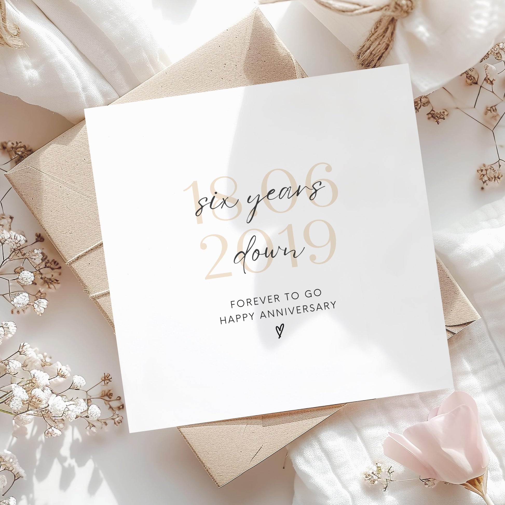 Personalised six-year anniversary card featuring soft beige date, script text reading “Six Years Down”, and a small heart detail.