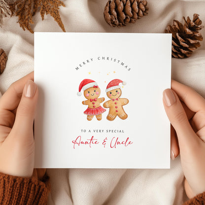 Personalised Christmas card for Auntie and Uncle featuring a cute gingerbread couple wearing Santa hats with festive Christmas wording.