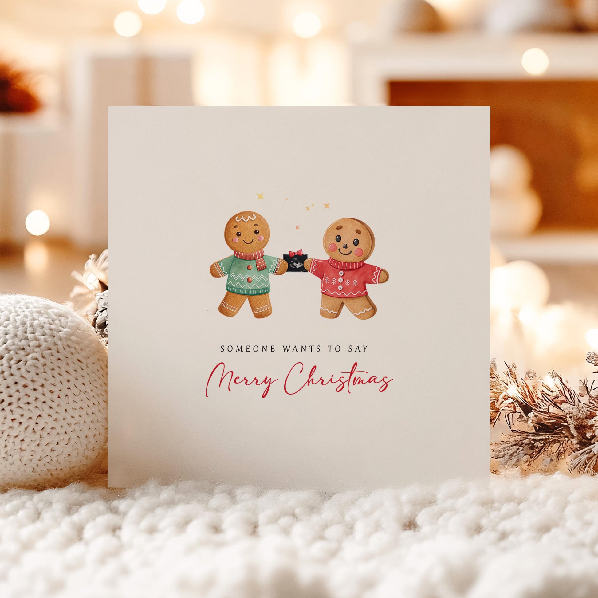 Christmas card with two gingerbread men holding a baby scan and the words “Someone wants to say Merry Christmas” – festive pregnancy reveal for gay couple.