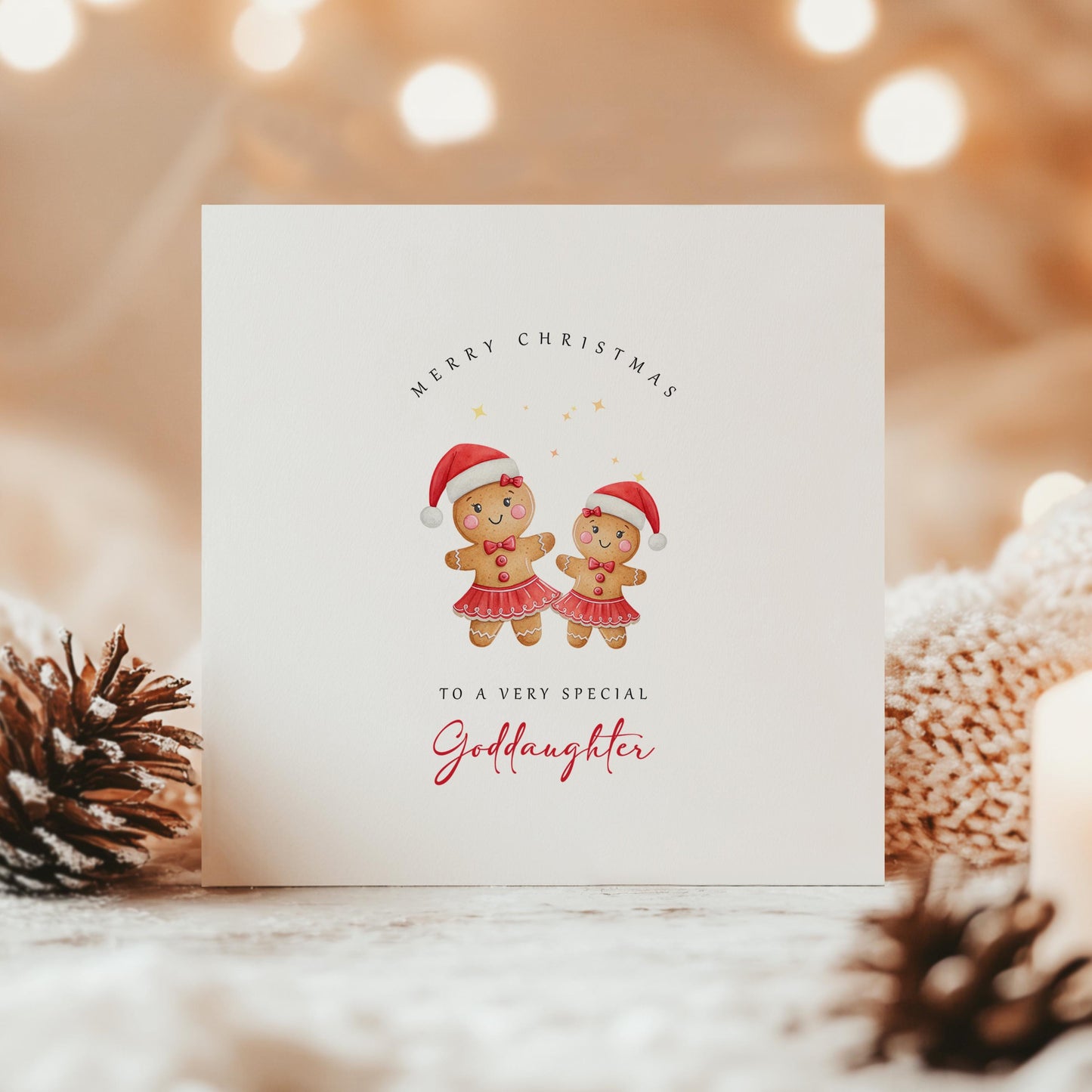 Christmas card featuring two gingerbread girls in Santa hats with the text “Merry Christmas to a very special Goddaughter” on a cosy festive background.