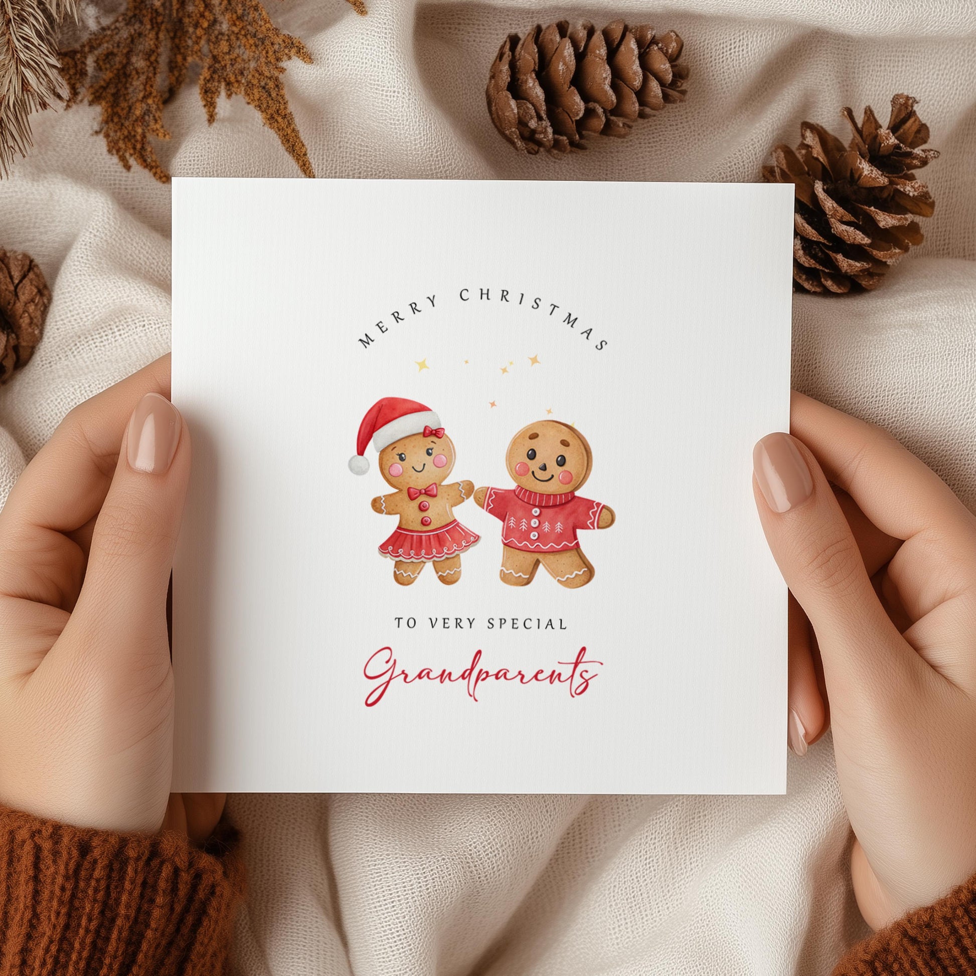 Christmas card for grandparents featuring a festive gingerbread couple wearing Christmas outfits.
