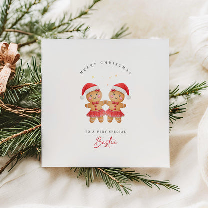 Best Friend Christmas card featuring two smiling gingerbread girls wearing Santa hats and festive skirts.