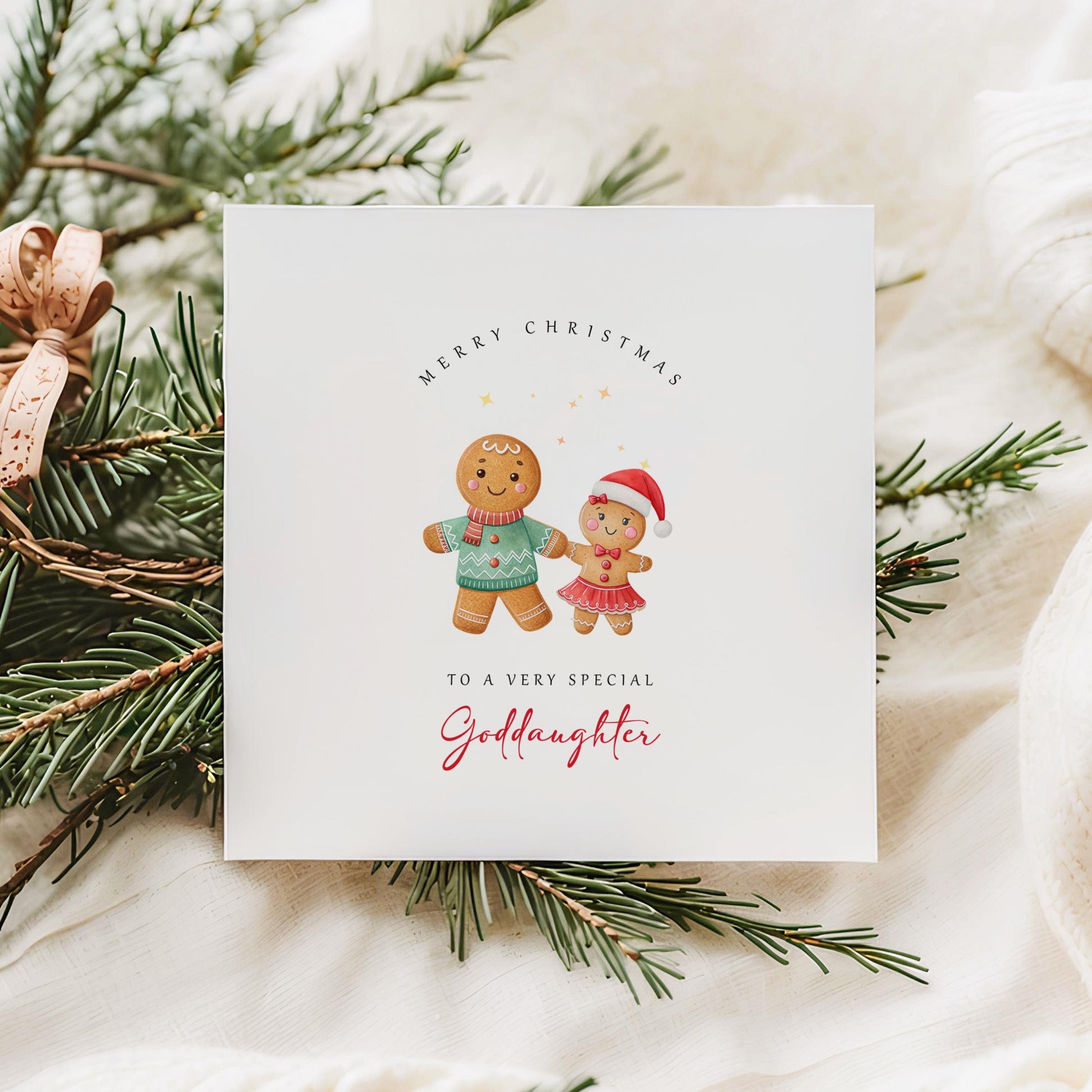 Christmas card from godfather to goddaughter with two gingerbread girls in Santa hats, set against a festive, cosy holiday background.