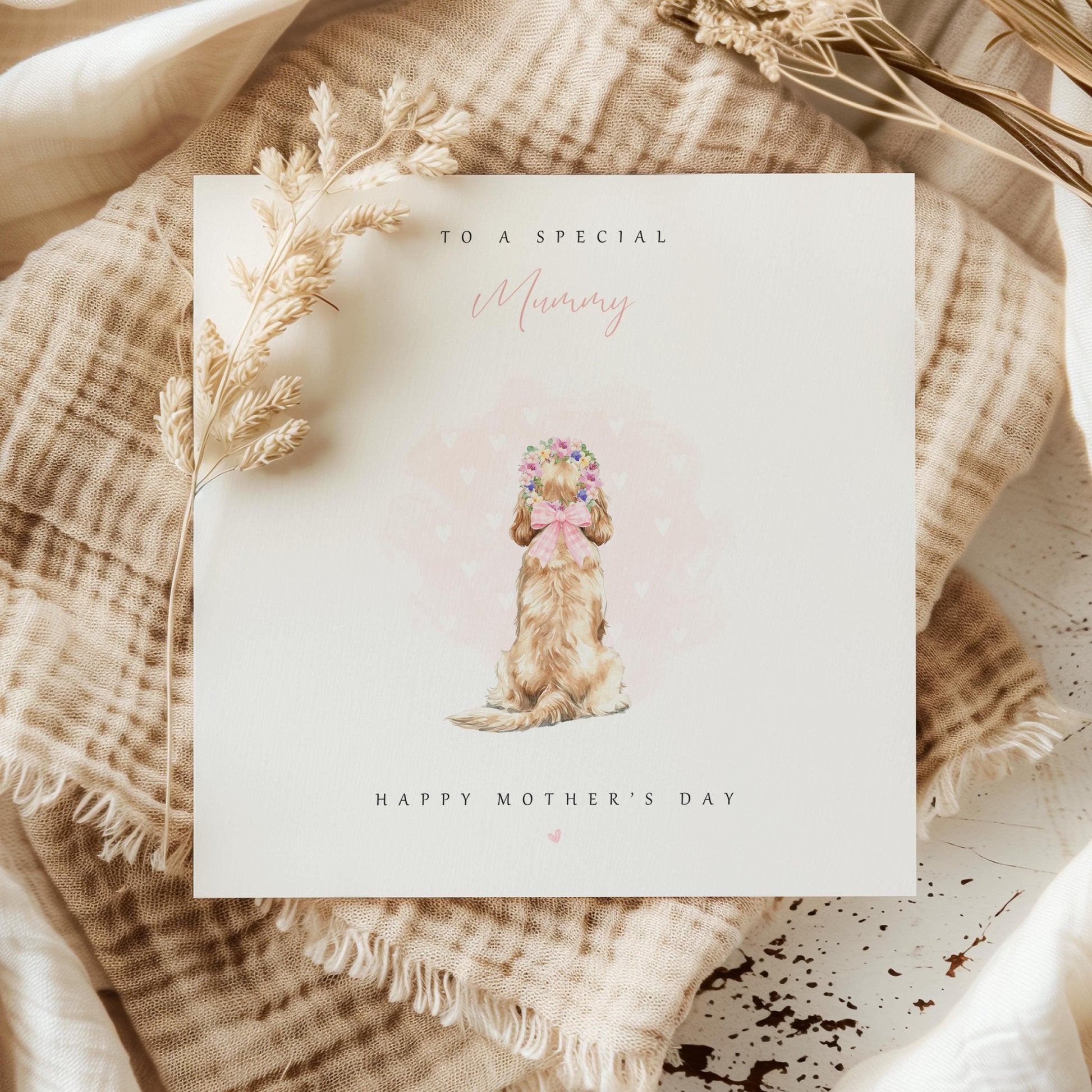 Watercolour Mother’s Day card from the pet, showing a fluffy dog from behind with a flower crown and pink hearts, with the text “To a special Mummy, Happy Mother’s Day” on a neutral background.