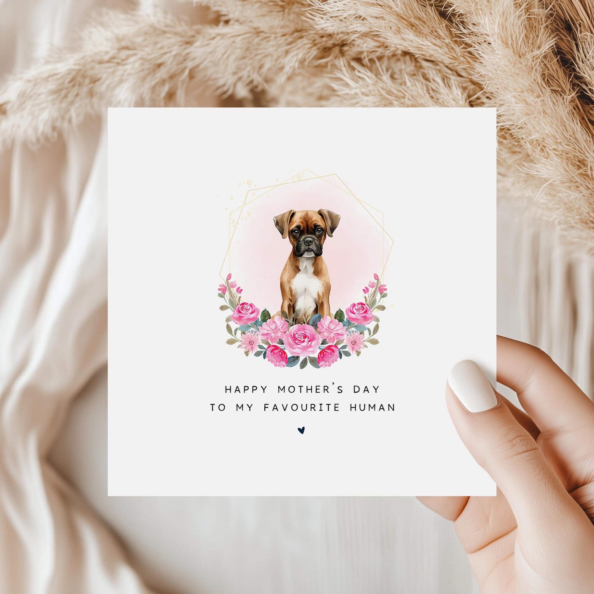 Square Mother’s Day card showing a Boxer dog sitting in a pink floral wreath with the text “Happy Mother’s Day to my favourite human” on a white card with pastel green background.