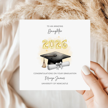 Personalised daughter graduation card featuring graduation cap, diploma scroll and custom graduation year. Personalised with graduate’s name, university and wording. Keepsake congratulations card for university or college graduation.