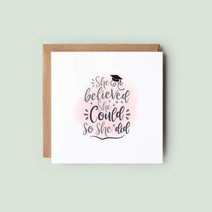 Graduation card for her featuring the quote “She Believed She Could So She Did” with a graduation cap and soft pink background. Inspirational congratulations card for female university graduates, college graduates and academic achievements.
