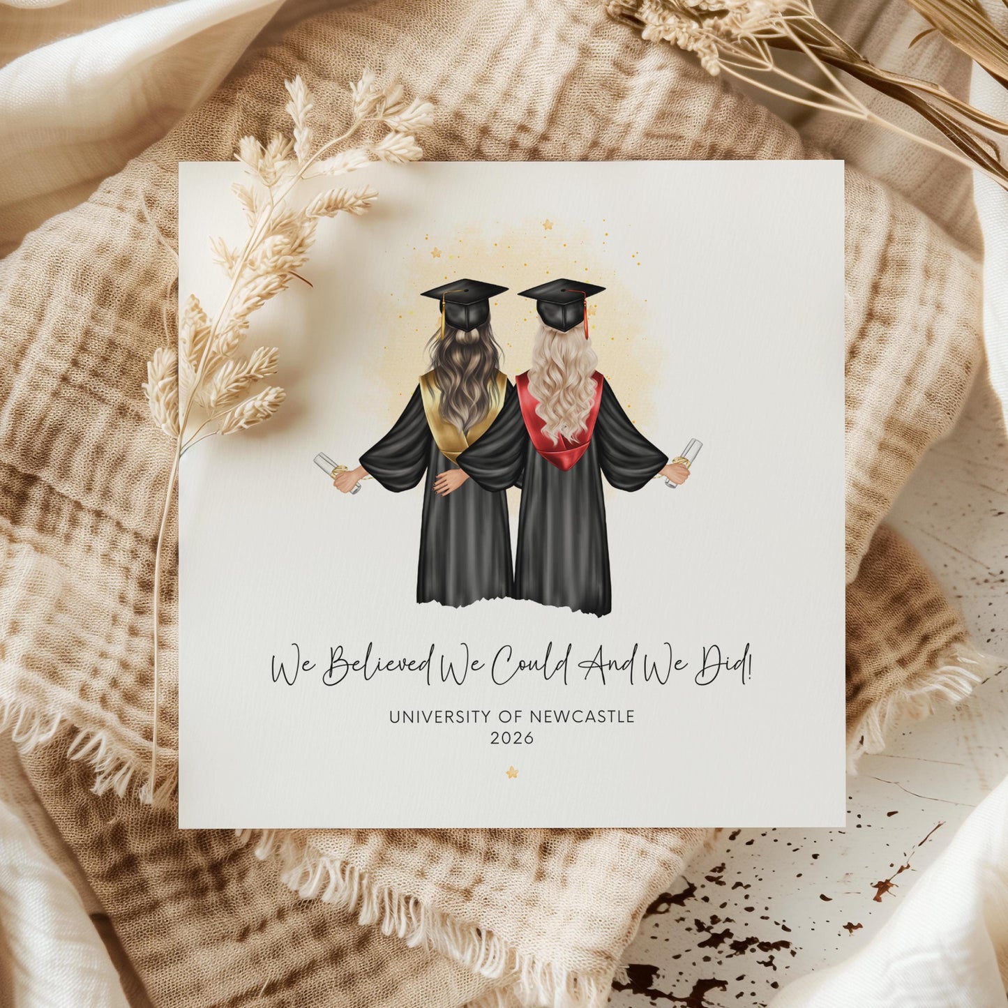 Personalised best friend graduation card featuring two graduates in caps and gowns holding diplomas. Customisable hair, skin tone, sash colours, university name, graduation year and friendship quote for Class of 2026 graduates.