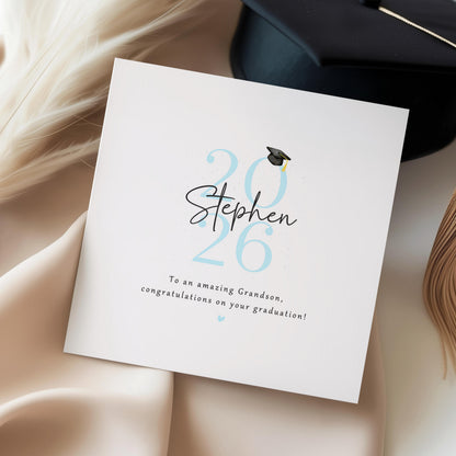 Personalised grandson graduation card from Nan and Grandad featuring custom name, graduation year and congratulations message with graduation cap illustration.