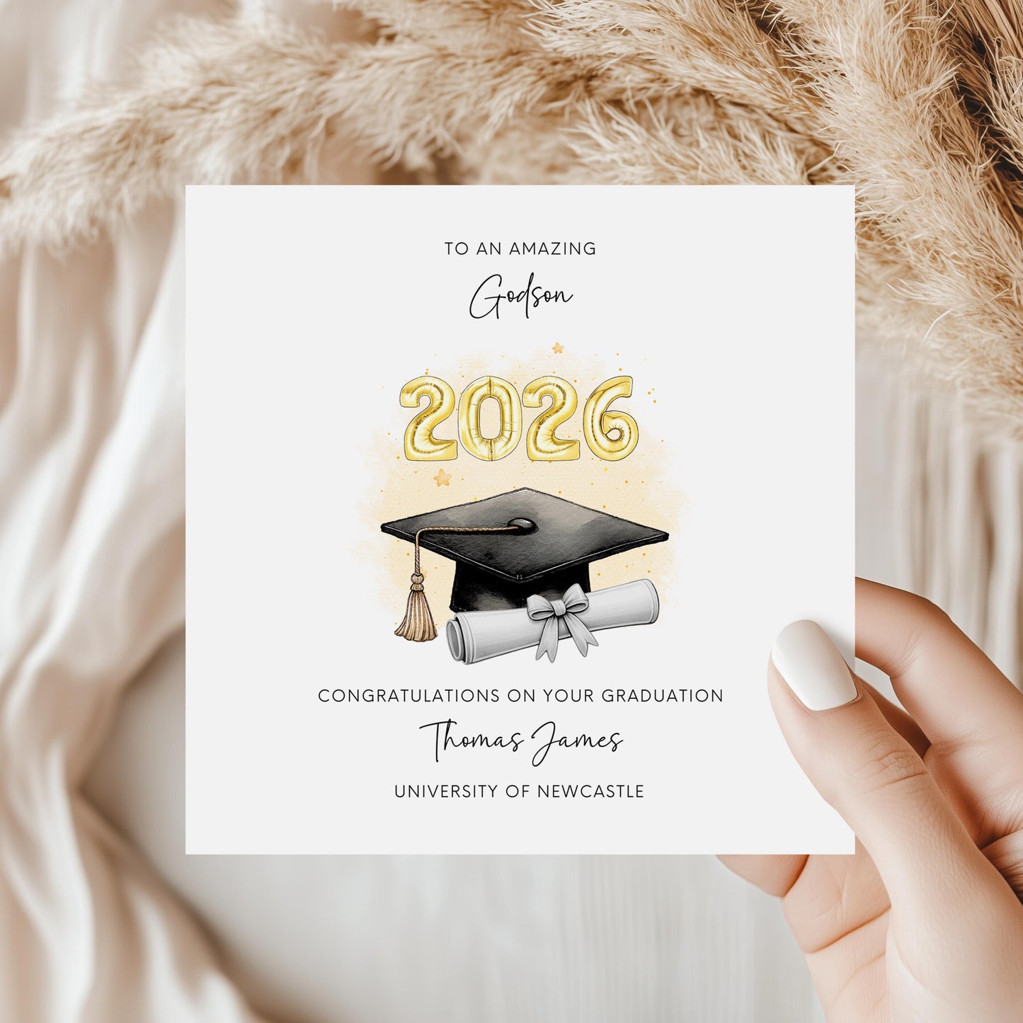 Personalised godson graduation card featuring gold 2026 balloons, graduation cap and diploma scroll. Custom university graduation card with godson title, graduate name, university details and congratulations message.