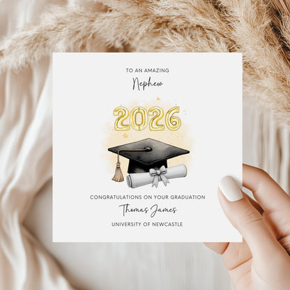 Personalised nephew graduation card featuring gold 2026 balloons, graduation cap and diploma scroll. Custom university graduation card with nephew title, graduate name, university details and congratulations message.