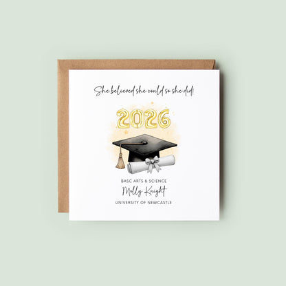 Personalised graduation card for her featuring gold 2026 balloons, graduation cap and diploma scroll. Custom graduate card with degree title, name, university and inspirational graduation quote for Class of 2026.
