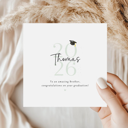 Personalised Brother Graduation Card featuring graduate name, Class of 2026 design, graduation cap illustration and congratulatory message on a modern keepsake card.