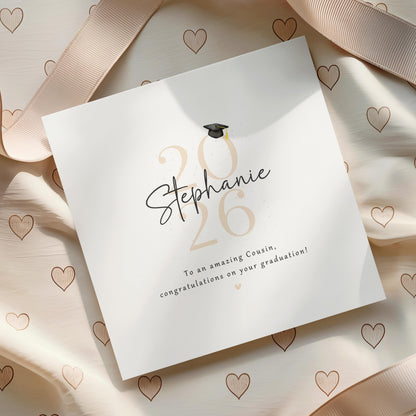 Personalised cousin graduation card featuring custom name, graduation year and congratulatory message with graduation cap design and recycled Kraft envelope.