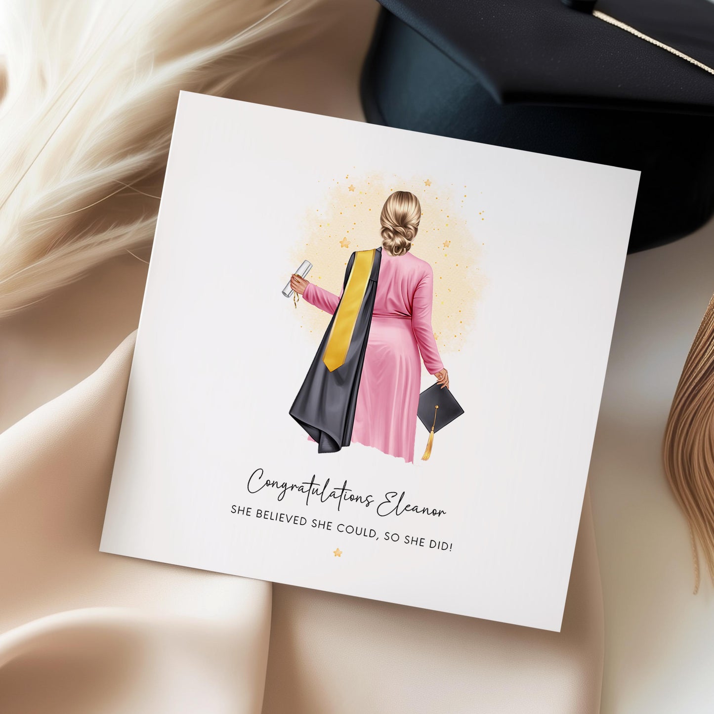 Personalised graduation card featuring a female graduate illustration with custom hair, skin tone, outfit, robe and sash colours, holding a diploma and graduation cap.