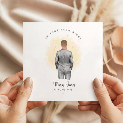 Personalised prom card featuring a male figure in a silver suit with custom name and prom date.