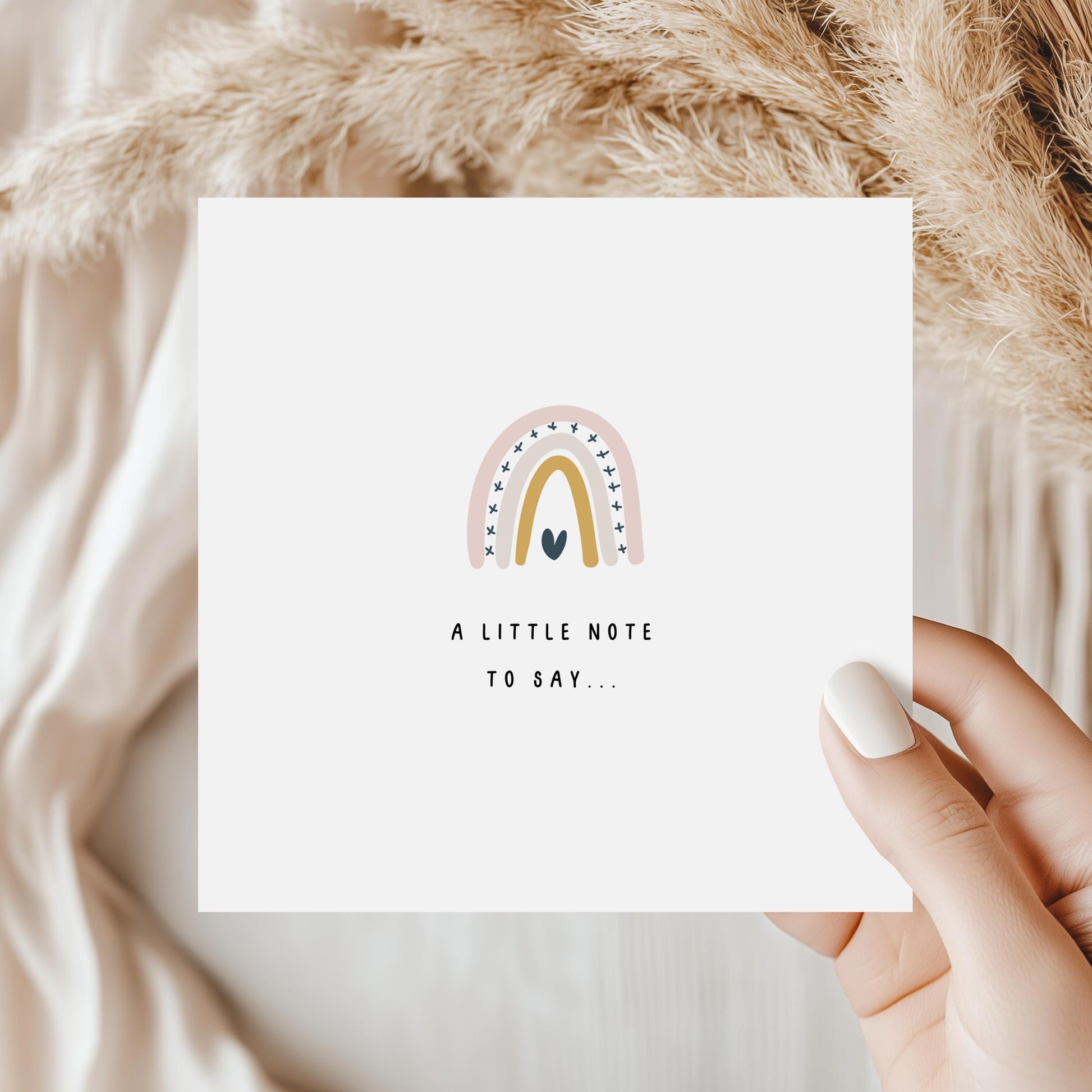 Minimalist graduation greeting card featuring a soft neutral rainbow with a small heart and the words A Little Note to Say, perfect for writing a congratulations message to a graduate.