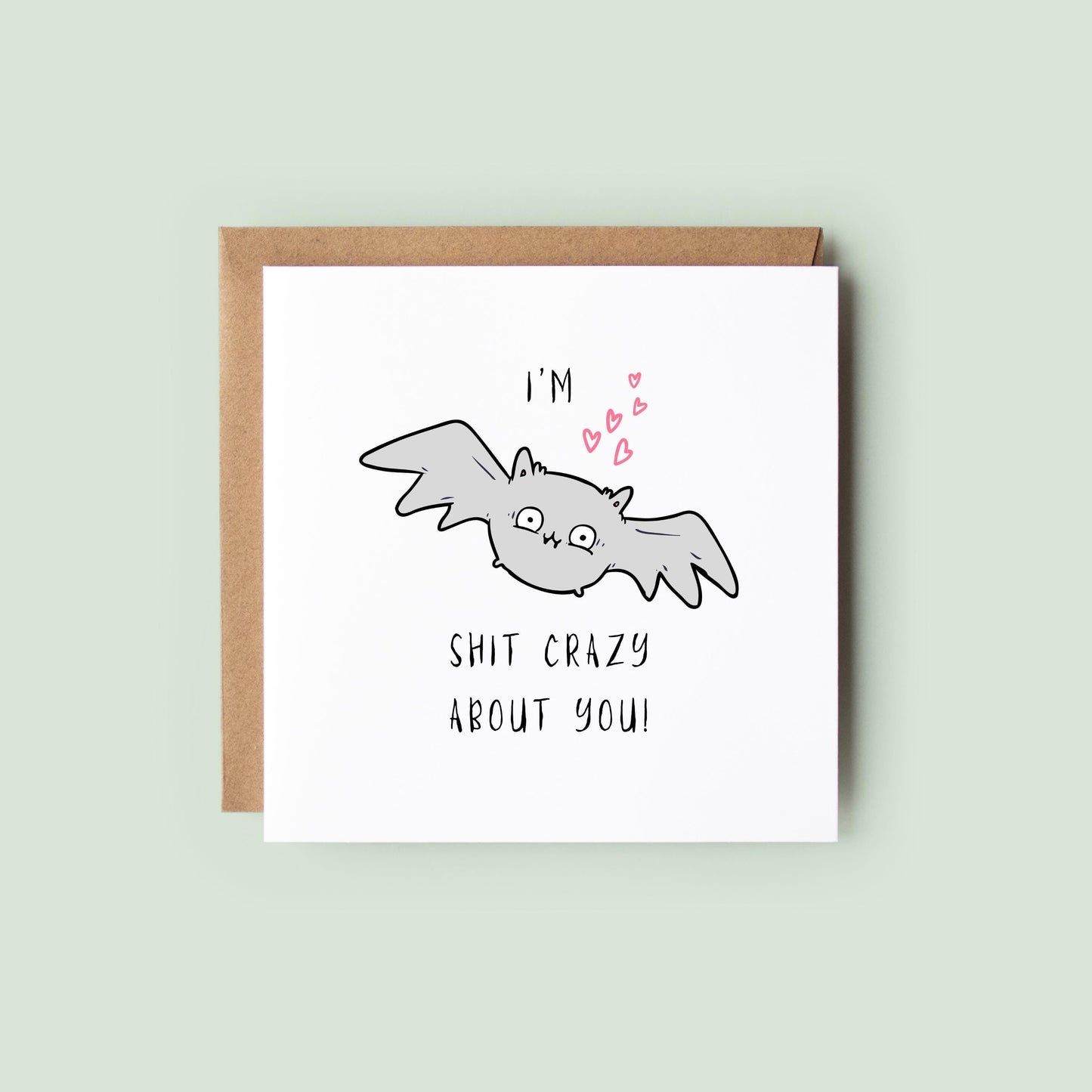 Funny Halloween greeting card featuring a cute grey bat with pink hearts and the humorous message "I'm Bat Shit Crazy About You."