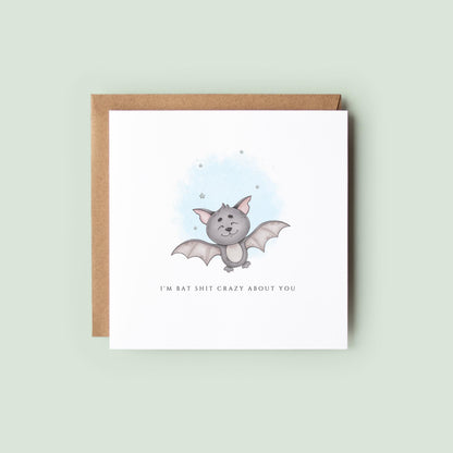 Cute watercolour Halloween greeting card featuring an adorable smiling bat with the humorous message "I'm Bat Shit Crazy About You."