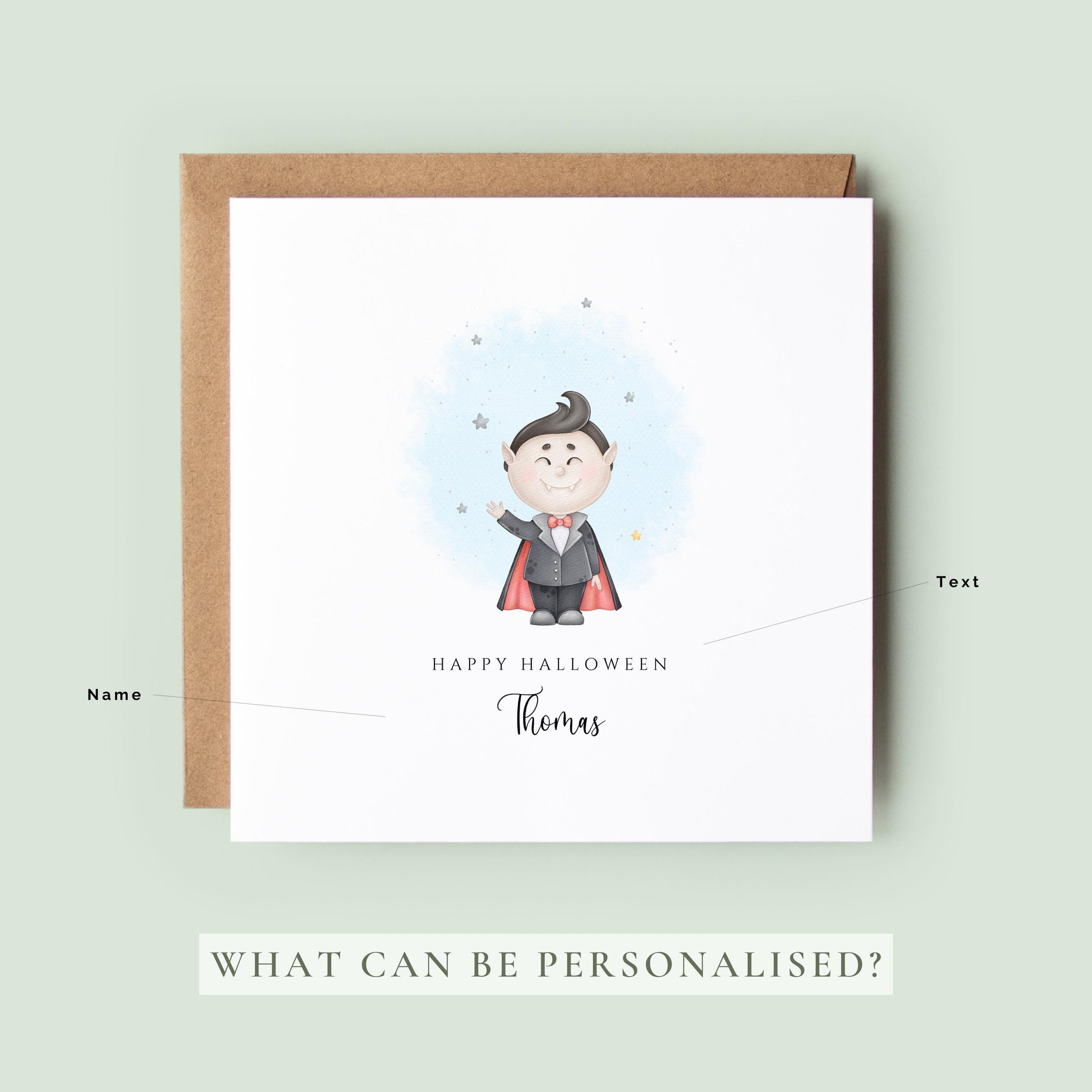 Personalised Halloween card featuring a cute smiling vampire in a cape with a custom name underneath and the words "Happy Halloween" on a white greeting card.