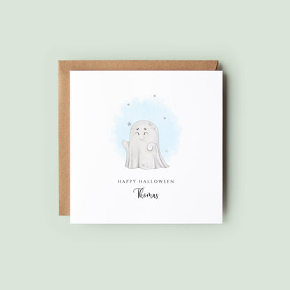 Personalised Halloween greeting card featuring a cute smiling ghost with a custom name underneath and the words "Happy Halloween" on a white card.