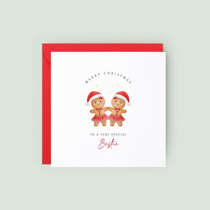 Best Friend Christmas card featuring two smiling gingerbread girls wearing Santa hats and festive skirts.