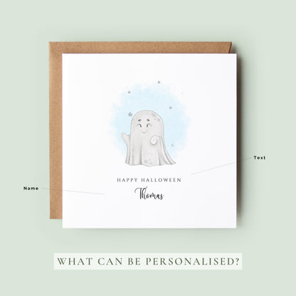 Personalised Halloween greeting card featuring a cute smiling ghost with a custom name underneath and the words "Happy Halloween" on a white card.