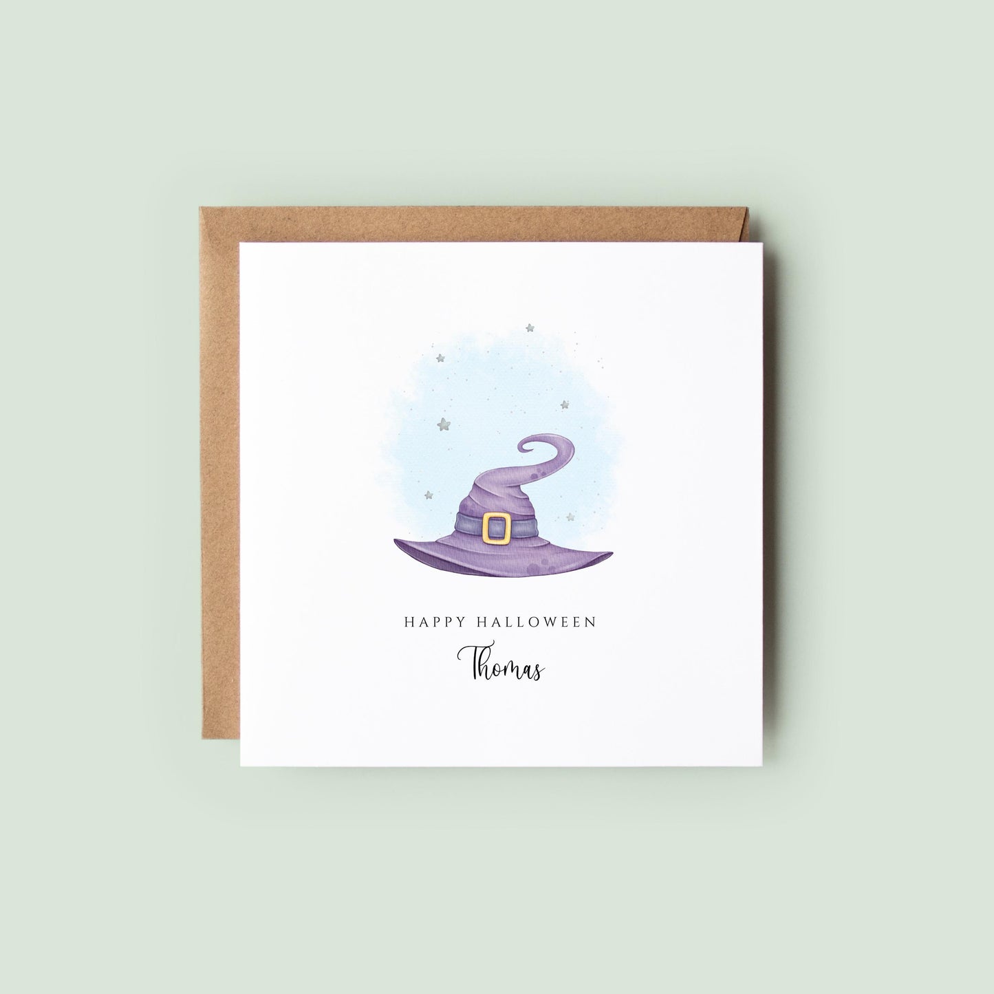 Personalised Halloween greeting card featuring a purple watercolour witch's hat with a custom name underneath and the words "Happy Halloween" on a white card.