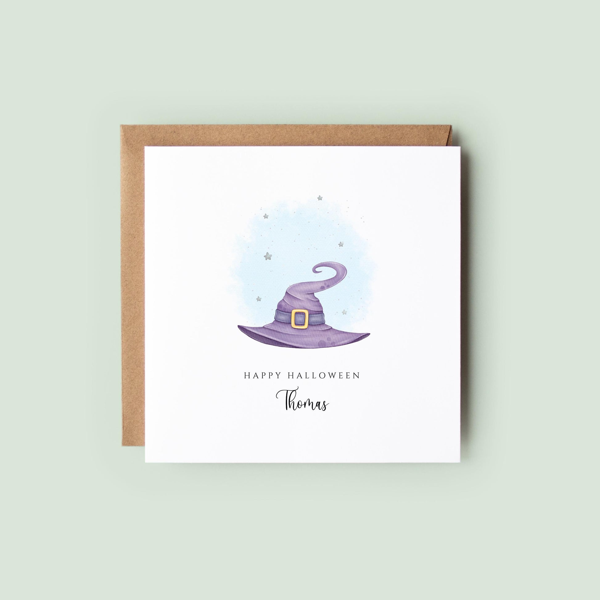 Personalised Halloween greeting card featuring a purple watercolour witch's hat with a custom name underneath and the words "Happy Halloween" on a white card.