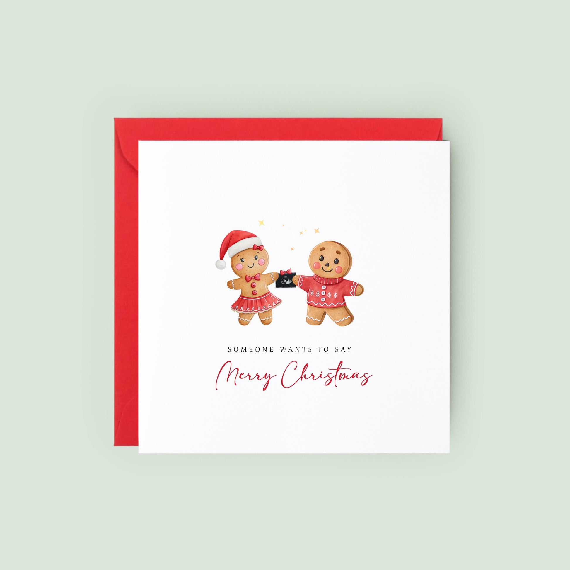 Christmas pregnancy announcement card featuring a festive gingerbread couple holding a baby scan with the message "Someone Wants to Say Merry Christmas."