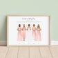 Framed personalised bridesmaid print showing bride and four bridesmaids illustrated from behind in blush dresses with bouquets, plus wedding date and names underneath, displayed in a light wood frame against a neutral background.