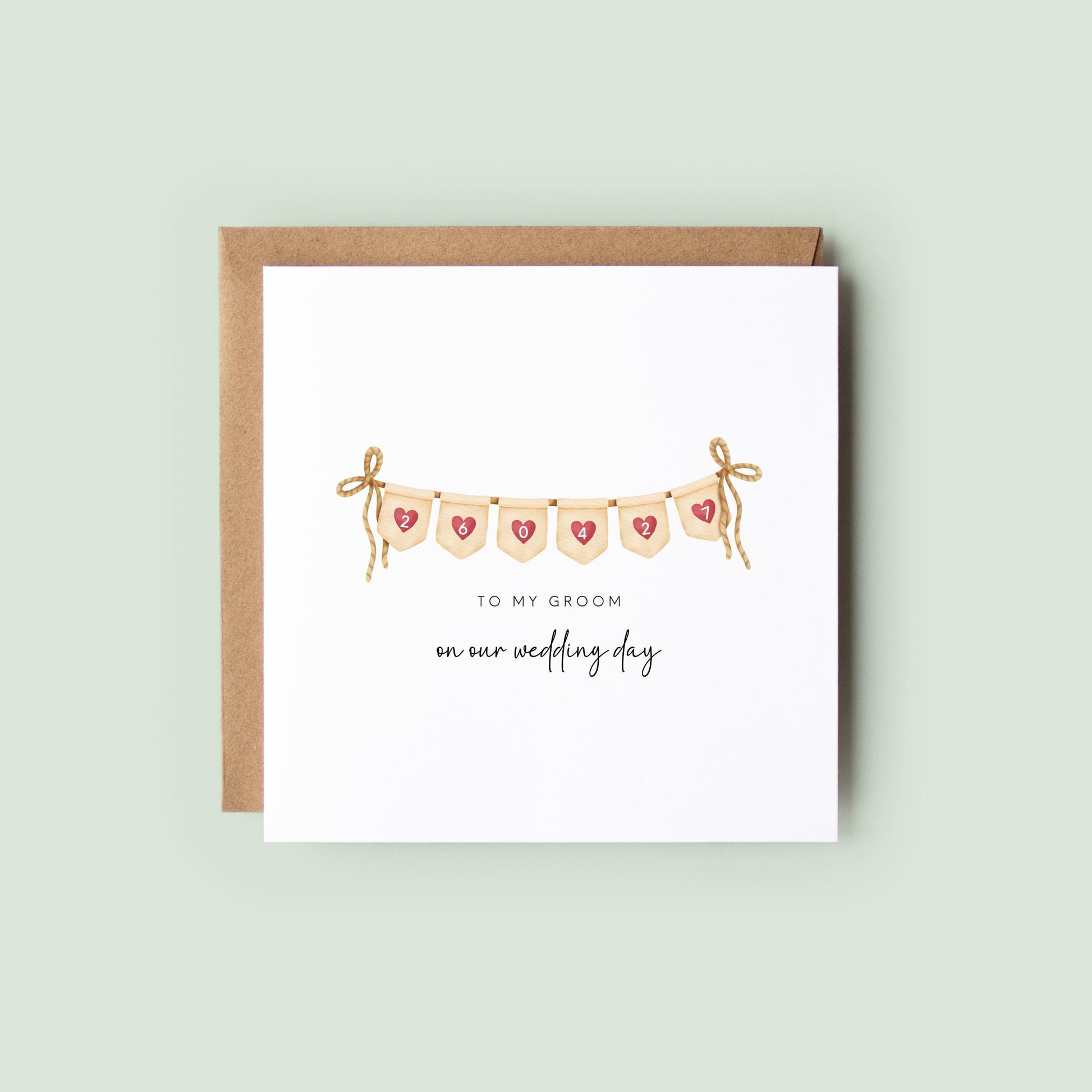 Personalised wedding day card for a groom with heart bunting and custom date, reading “To my groom on our wedding day”, shown as a square white 148x148mm (6x6) card with Kraft envelope behind.